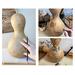 This shows a unfinished dried gourd in the design stages. A hummingbird and rose are being drawnon the goud using pyrography toos.